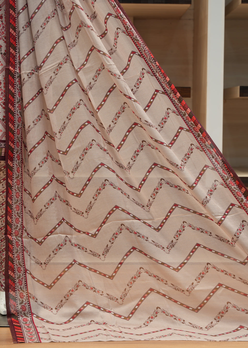 Close-up of a fabric with zigzag pattern on a wooden floor.