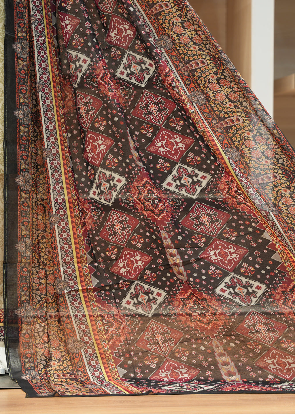 Decorative rug with intricate patterns on a wooden floor.