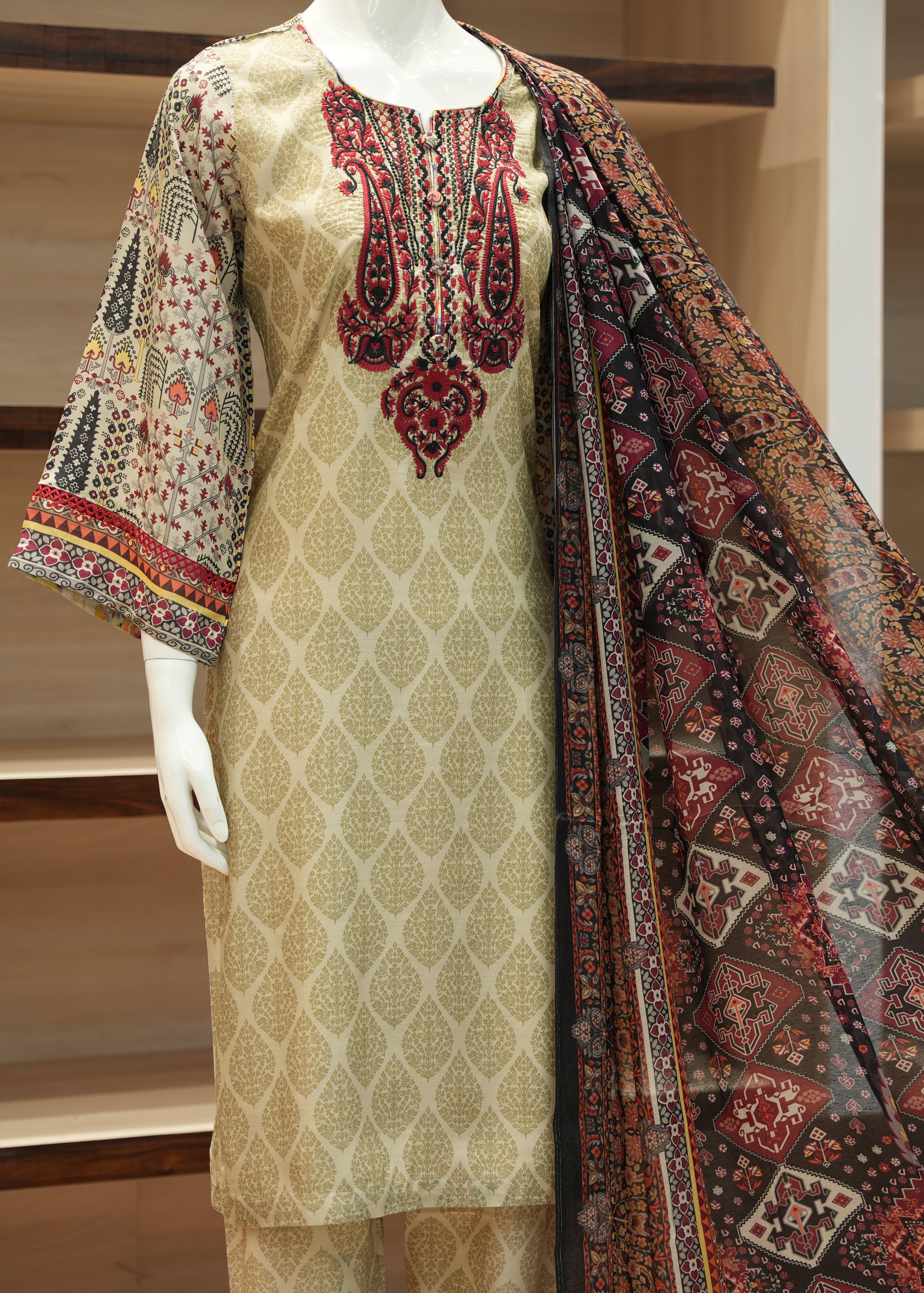 Traditional outfit with a patterned kurta and dupatta on a mannequin against a neutral background