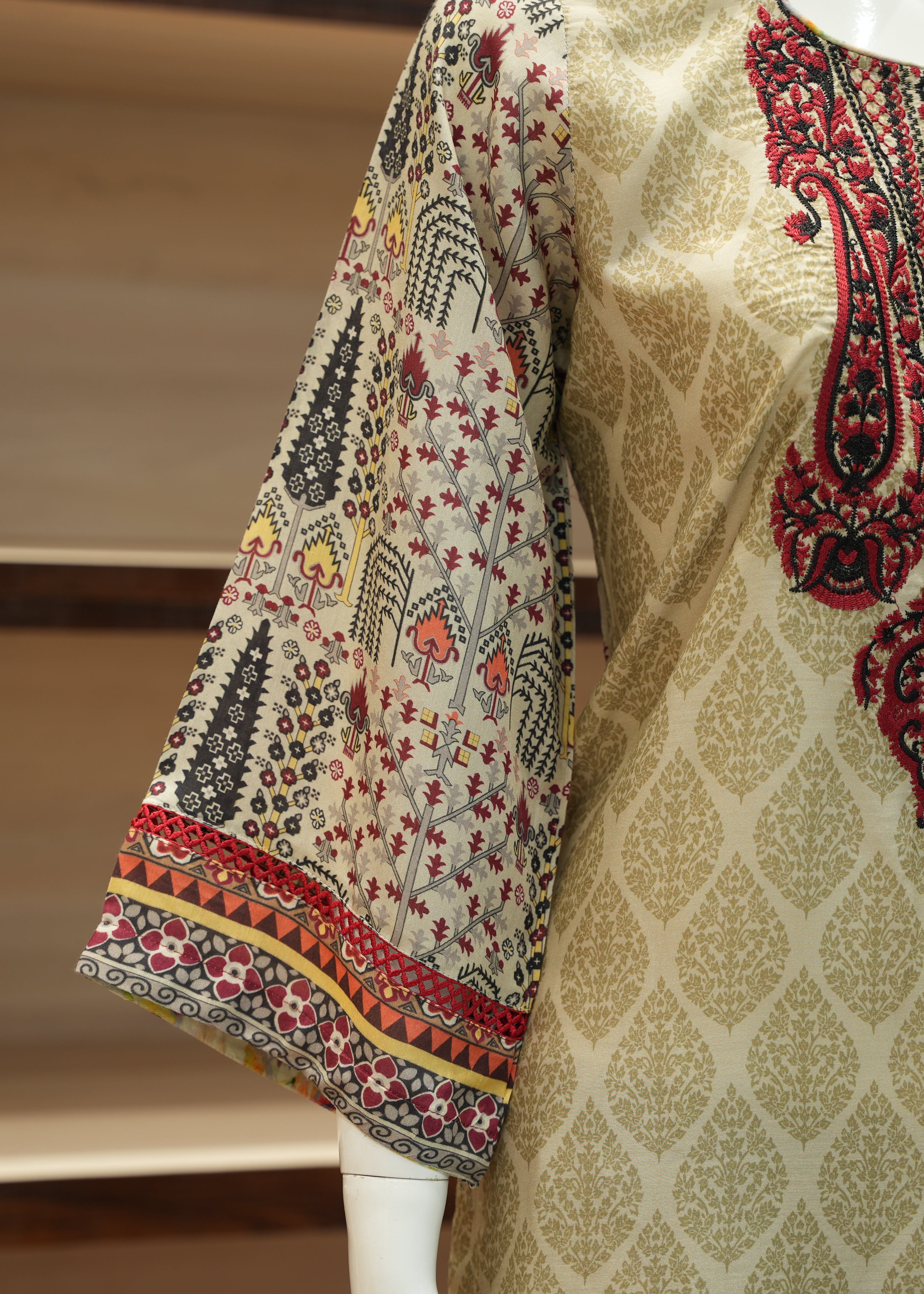 Traditional embroidered garment on a mannequin with a neutral background