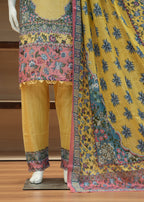 Traditional outfit with a yellow kurta, pants, and dupatta on a wooden stand.