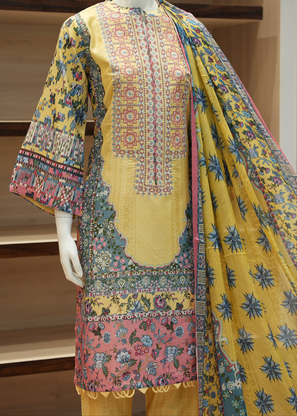 Colorful embroidered traditional outfit on a mannequin against a neutral background