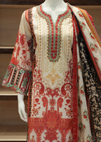 Traditional embroidered outfit with a shawl on a mannequin against a neutral background