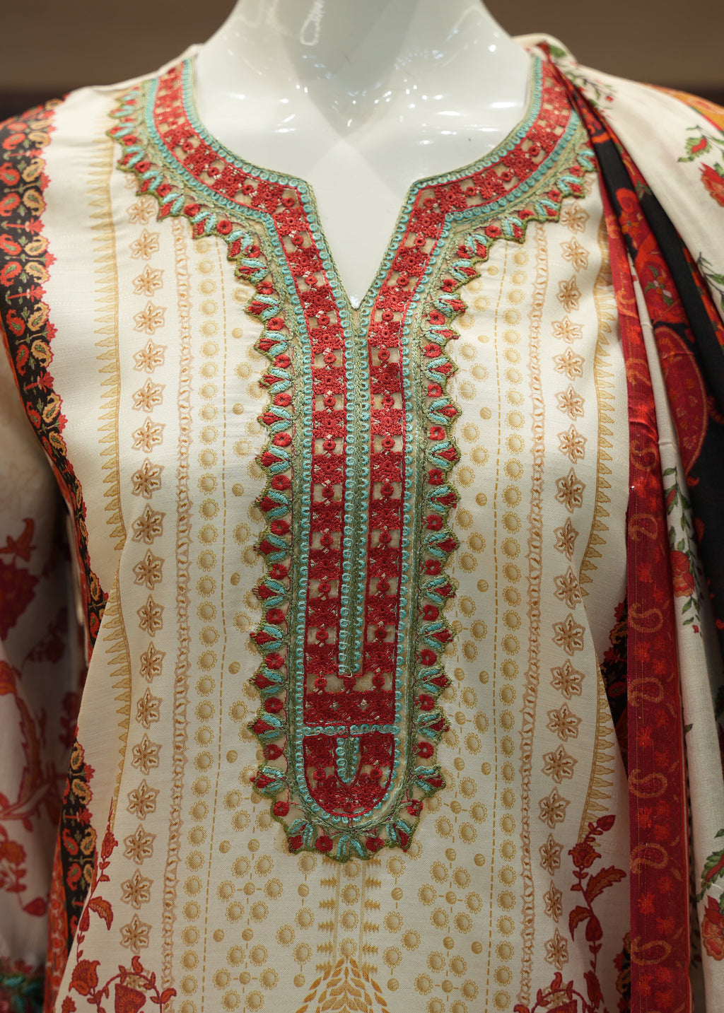 Embroidered garment on a mannequin with intricate patterns