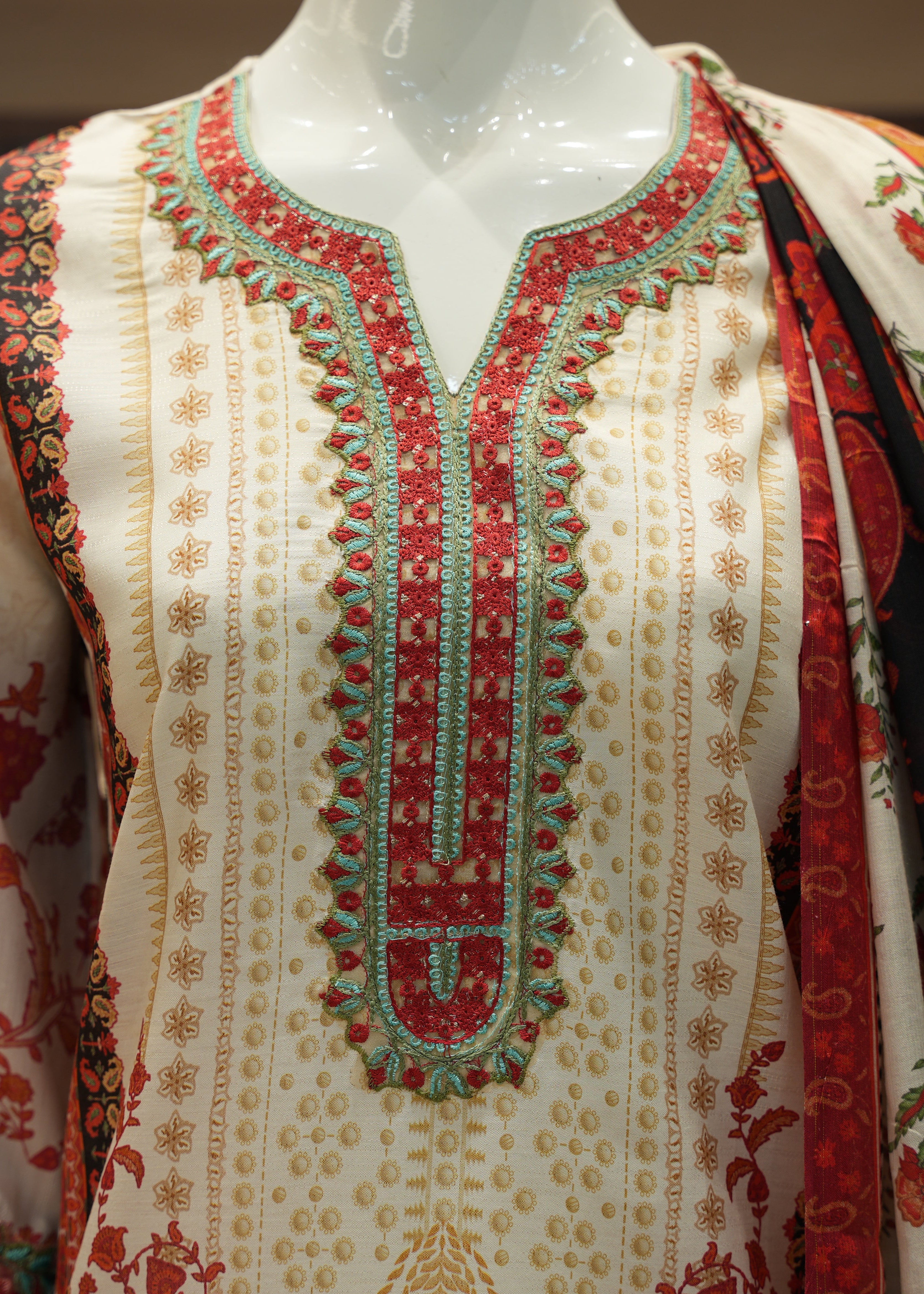 Embroidered garment on a mannequin with intricate patterns
