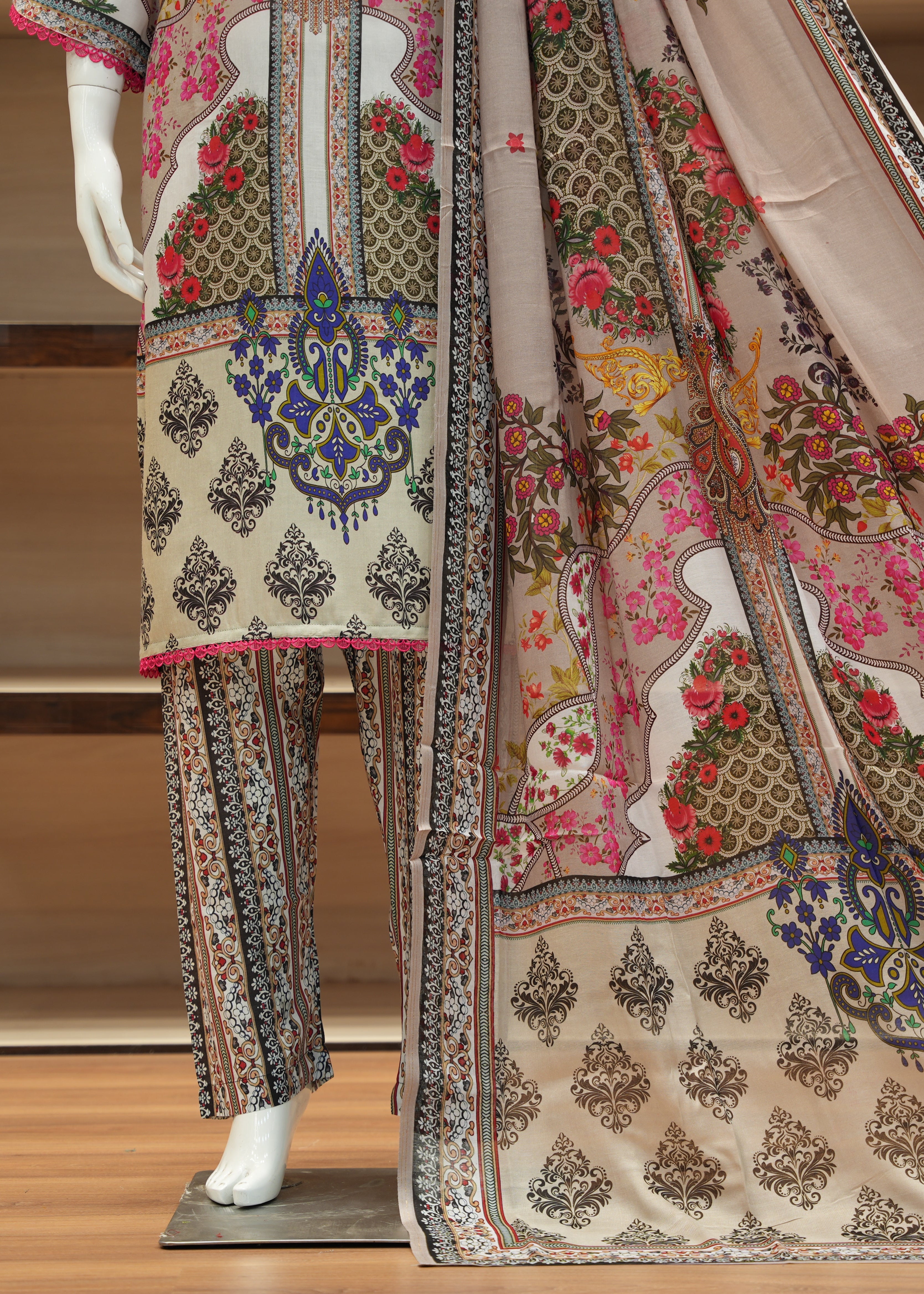 Traditional outfit with floral and paisley patterns on a mannequin.