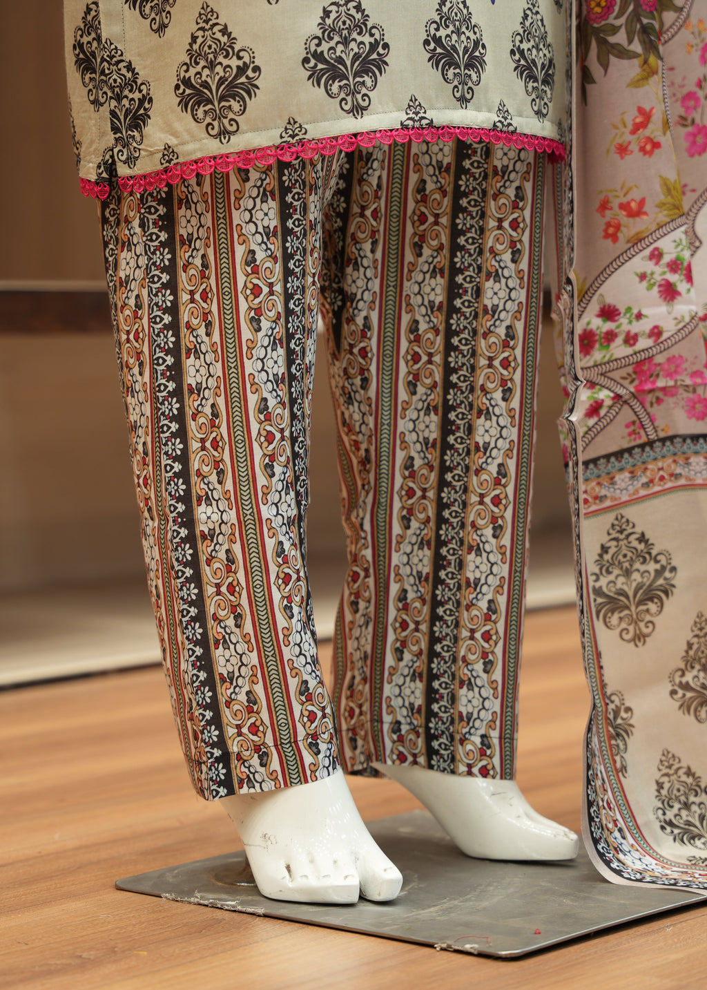 Traditional patterned pants and fabric on a wooden floor