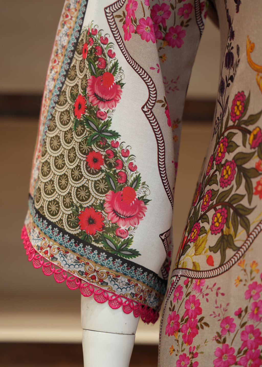 Colorful floral and geometric patterned fabric on a mannequin against a neutral background