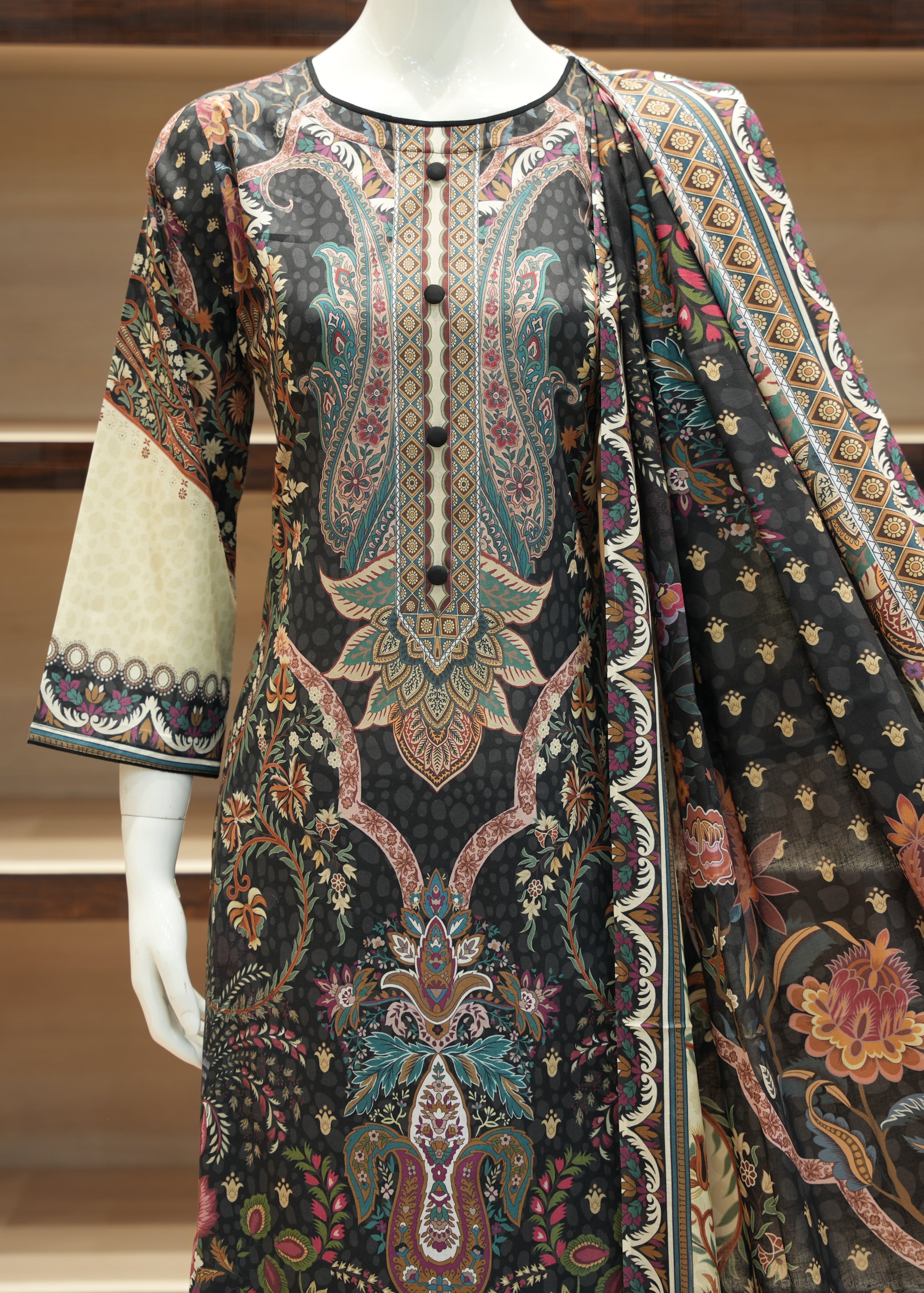 Traditional embroidered garment on a mannequin against a neutral background