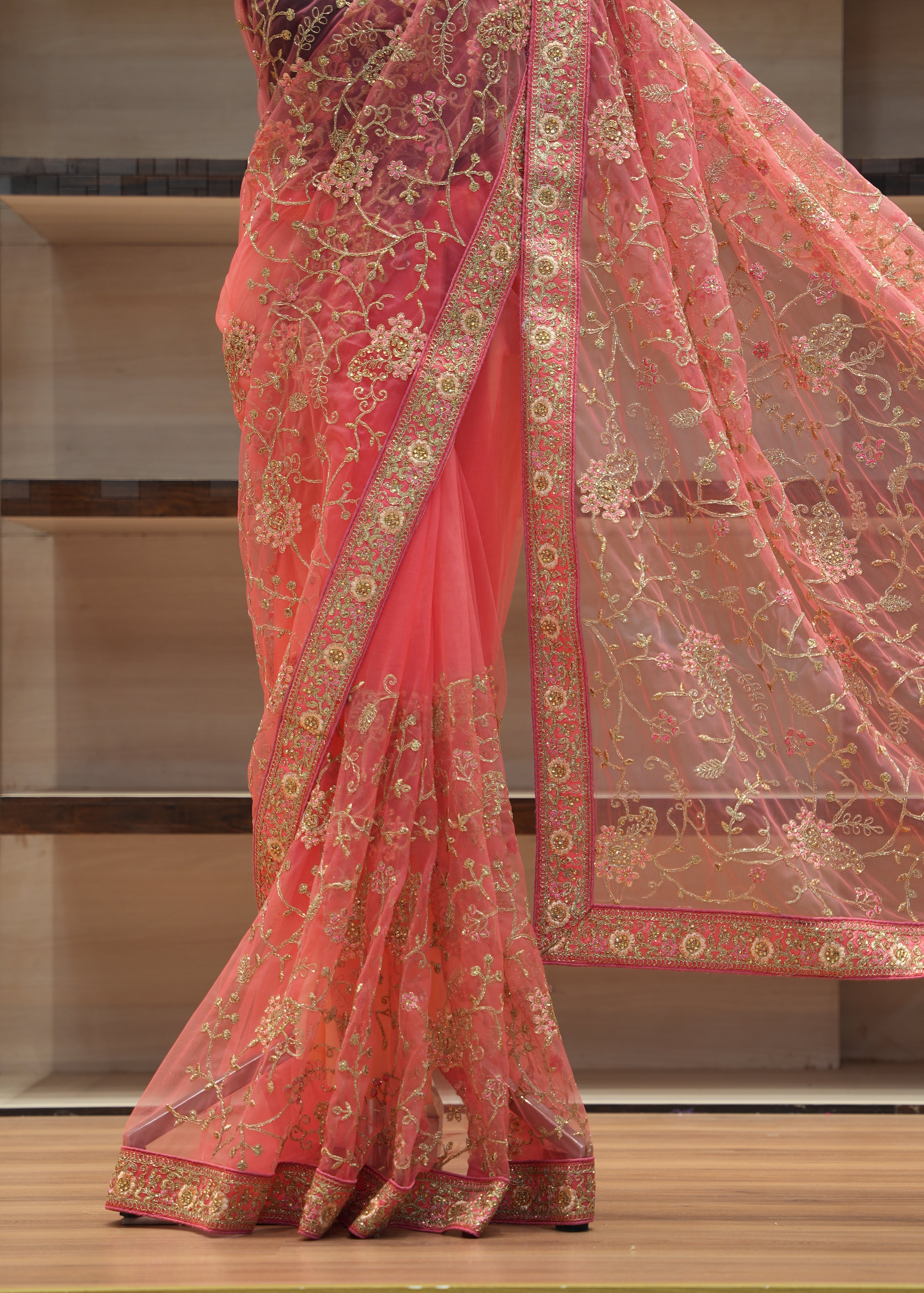 Red embroidered fabric draped over a wooden surface