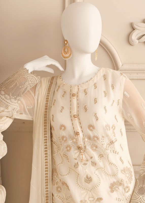 Woman in a cream embroidered outfit in an elegant room.