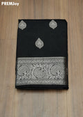 Black saree with white embroidery on a wooden surface, PREMJoy brand visible