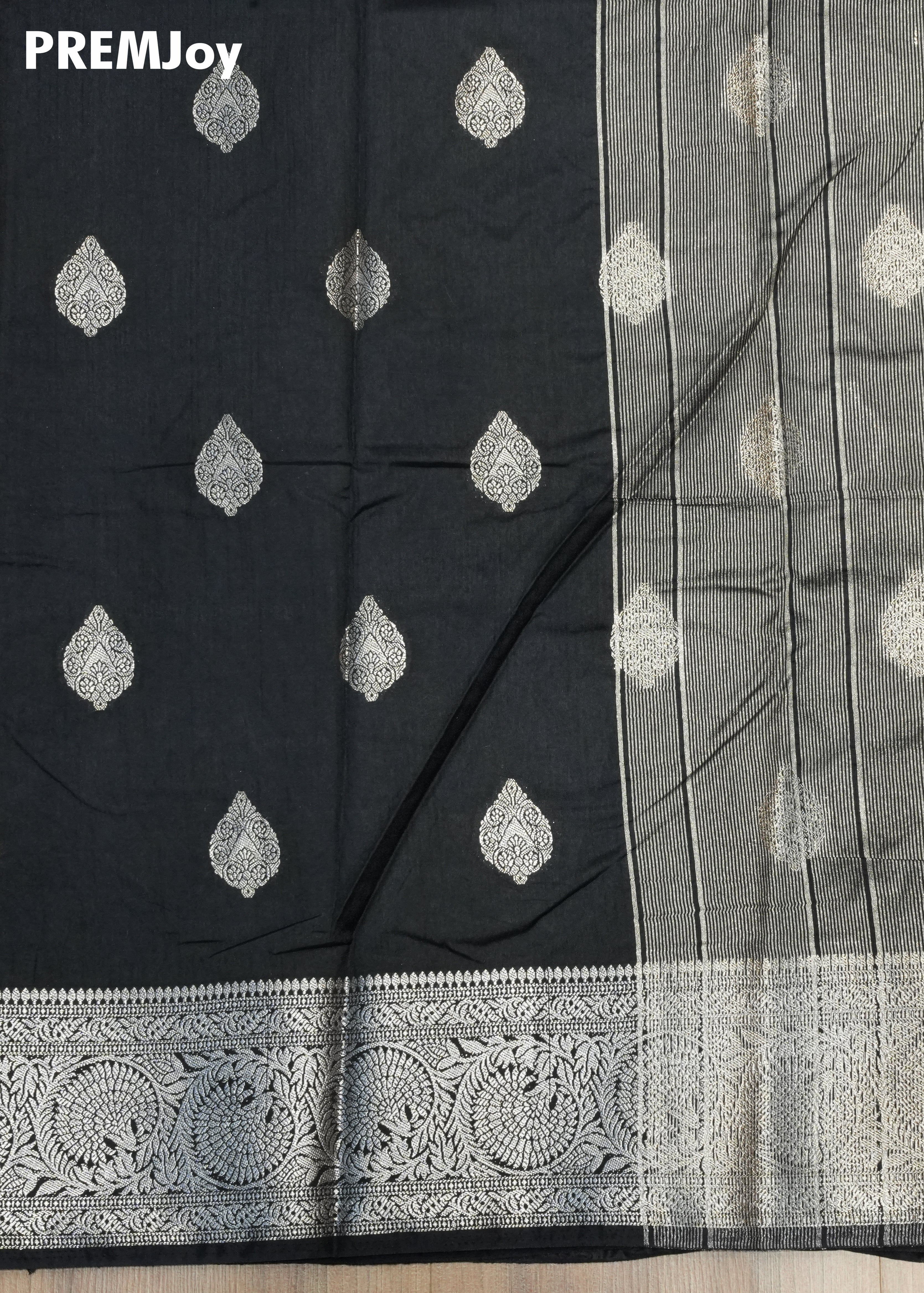 Black saree with silver embroidery and a visible brand name 'PREMJoy'.