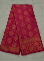 Red fabric with gold patterns on a light gray background