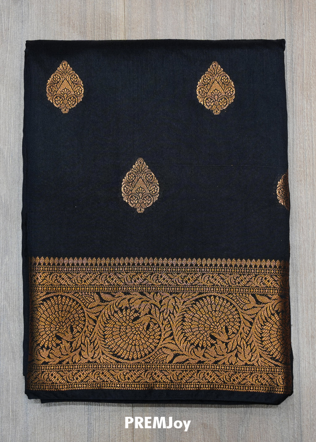 Black fabric with gold embroidery and 'PREMJoy' branding on a gray background