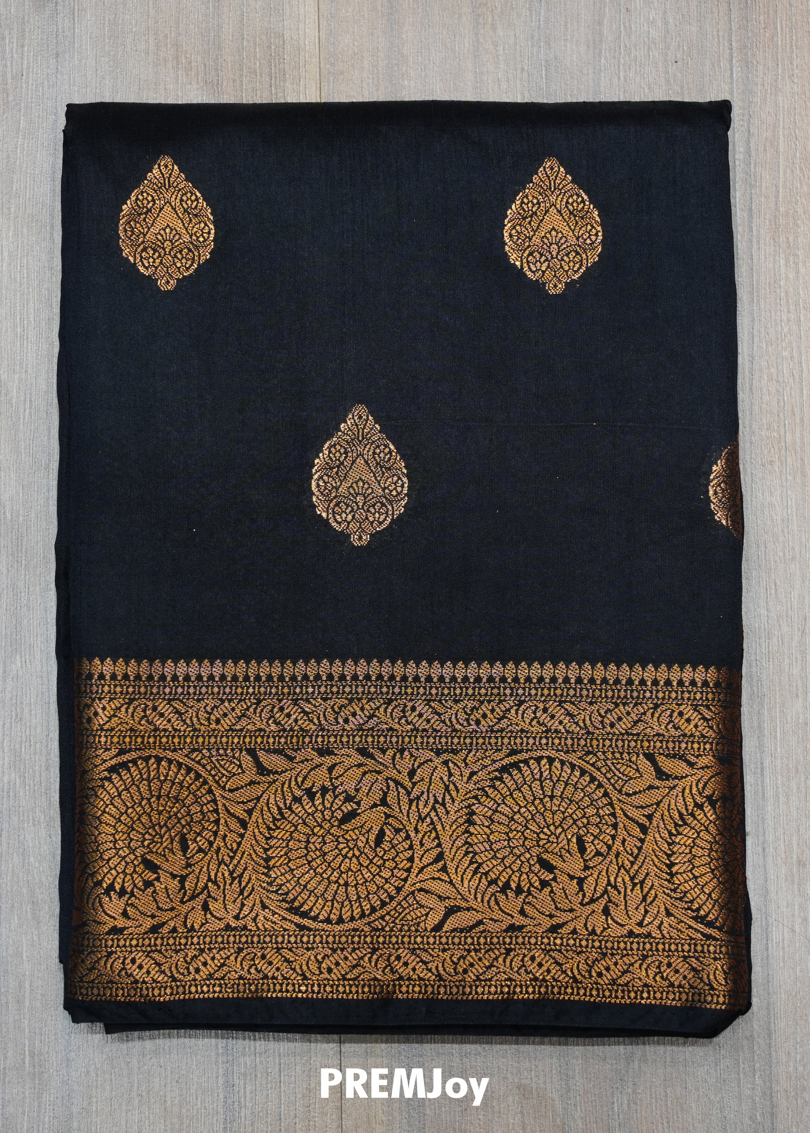 Black fabric with gold embroidery and 'PREMJoy' branding on a gray background