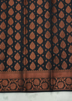 Black fabric with brown floral pattern on a white background