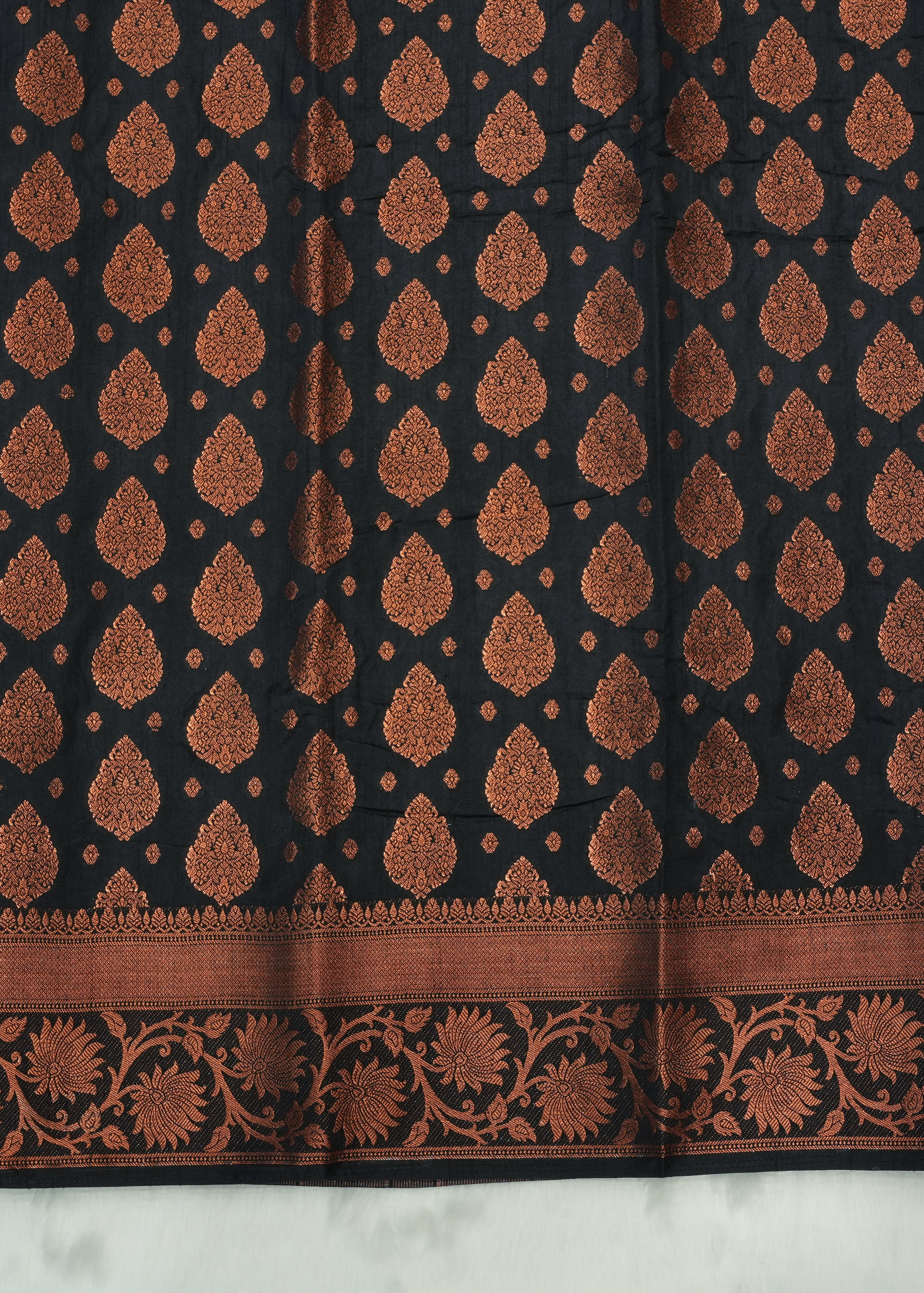 Black fabric with brown floral pattern on a white background