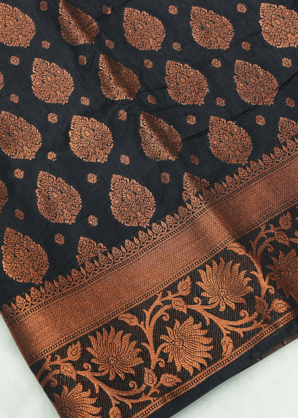 Black fabric with brown floral patterns on a white background