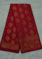 Red fabric with gold patterns on a white background