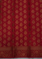 Red fabric with gold patterns on a gray background