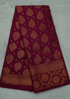 Maroon fabric with gold patterns on a white background
