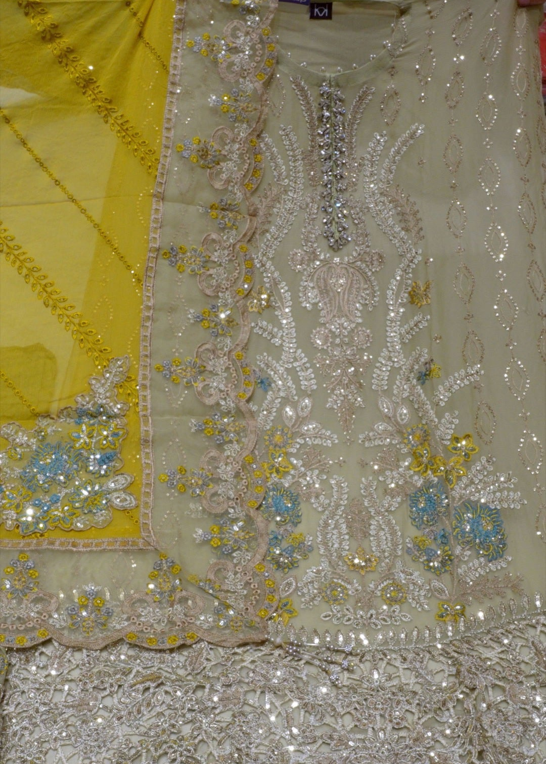 Decorative fabric with intricate patterns and embellishments, featuring the brand 'PREM Joy'.